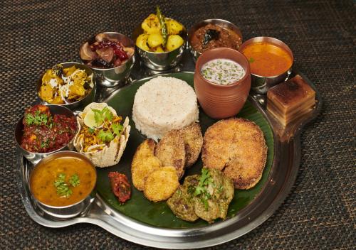 a plate of food with different types of food at The LaLiT Golf & Spa Resort Goa in Canacona