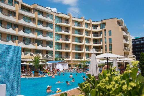 a group of people in a swimming pool in front of a hotel at Grenada Hotel in Sunny Beach