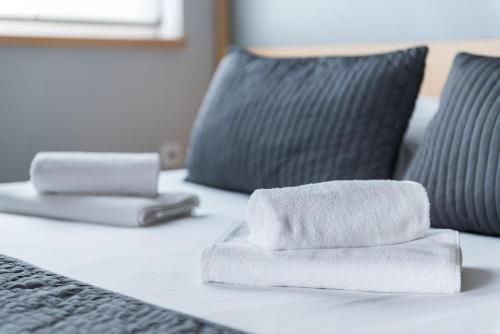 a pile of towels sitting on top of a bed at Weiser Hotel in Wrocław