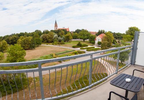 a balcony with a view of a park at Parkhotel Neubrandenburg in Neubrandenburg