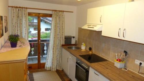 a kitchen with a sink and a counter top at Ferienwohnung Haus Oberlarchhof in Bayrischzell