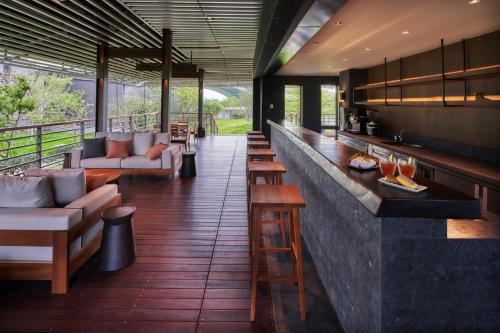 a bar with couches and chairs in a restaurant at Apexvilla-moon in Dongshan
