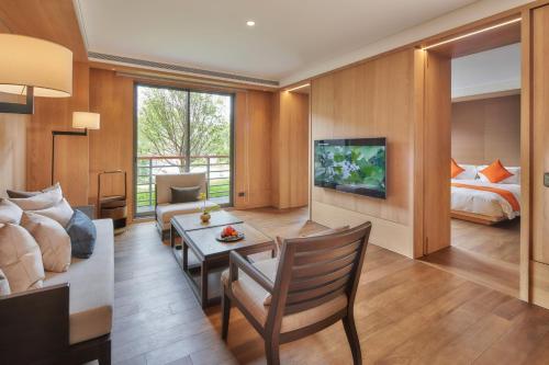 a living room with a couch and a bed at Apexvilla-moon in Dongshan