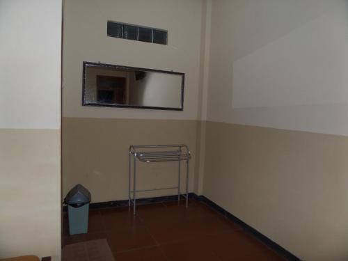 a empty room with a mirror on the wall at Kahyuna Guesthouse in Bromo