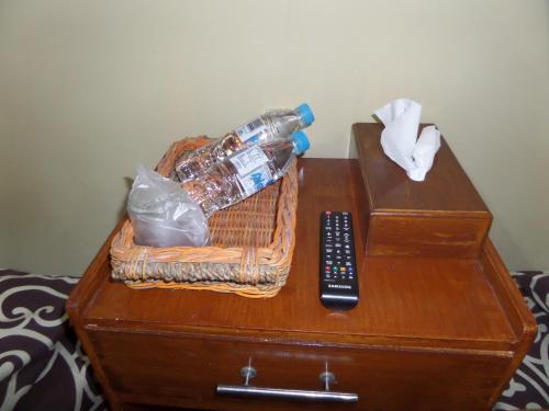 a basket of water bottles and a remote control on a table at Kahyuna Guesthouse in Bromo