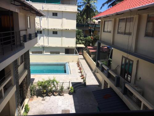 an aerial view of a building with a swimming pool at New Kovalam Beach Hotel in Kovalam
