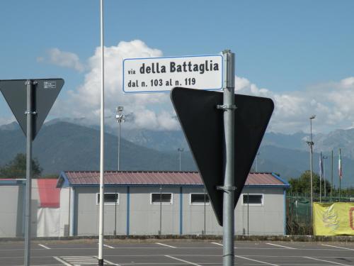 a street sign in a parking lot with a building at Tetto Nuovo B&B in Cuneo