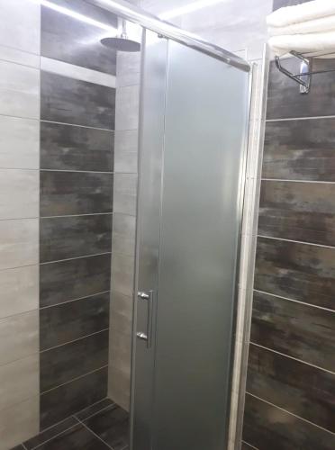 a shower with a glass door in a bathroom at Motel Calypso Travnik in Travnik