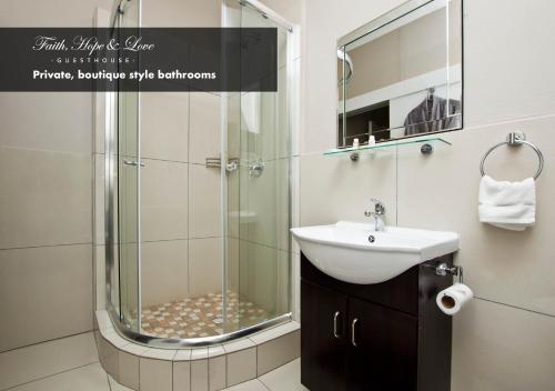 a bathroom with a shower with a sink and a mirror at Faith, Hope & Love Self Catering in Port Elizabeth