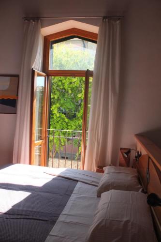 a bedroom with a bed and a large window at I Melograni in Sora