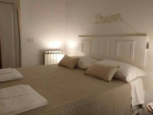 a bedroom with a large bed with white pillows at Anna Home in Chiaia in Naples