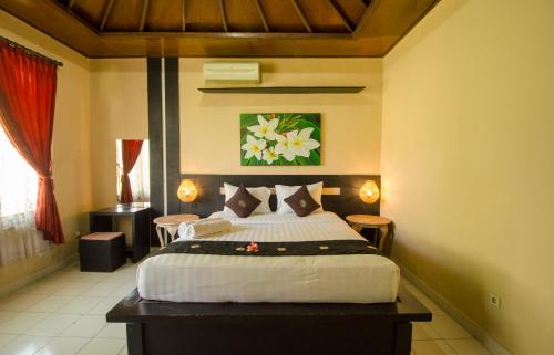 Кровать или кровати в номере Taman Sari Cottages