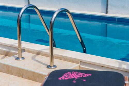 a suitcase sitting next to a swimming pool at Villa Dalmatian Gem in Gruda