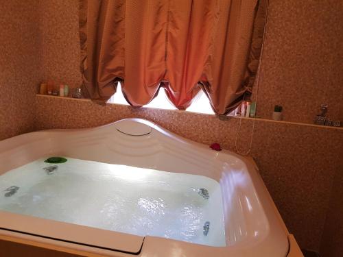 a bath tub in a bathroom with a window at La Bella Napoli B&B in Naples