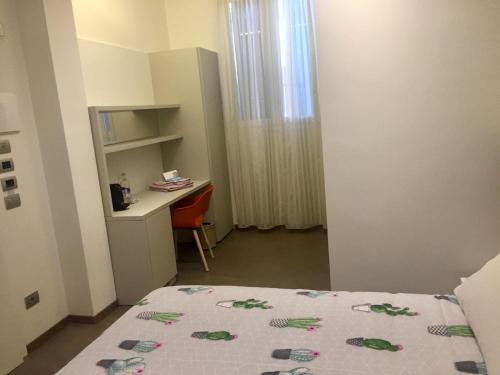 a small room with a bed and a desk at Alla Riva in Verona
