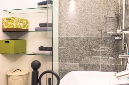 a bathroom with a shower and a sink at Spacious old town luxury apartment in Linz