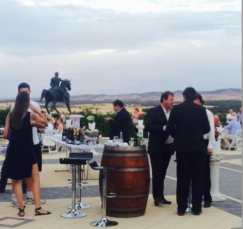 a group of people standing around a barrel at 1837 Barossa Luxury Vineyard Cottages in Lyndoch