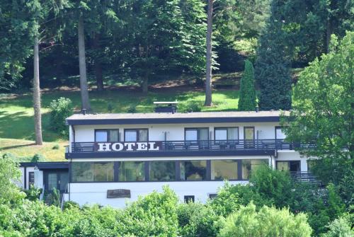 a building with a hotel sign on top of it at Haus am Wald in Eltmann