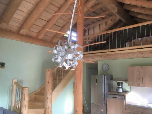 a chandelier hanging from a wooden ceiling in a kitchen at Holzhauszeit in Laudenbach