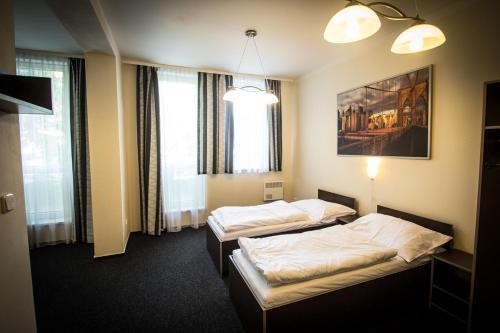 Postel nebo postele na pokoji v ubytování Hotel Sázavský Ostrov