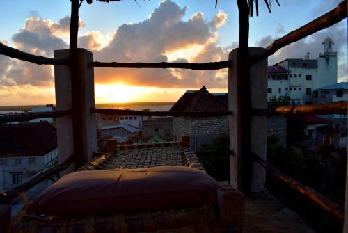 
a view from a balcony of a house with a view of the ocean at JamboHouse Lamu in Lamu

