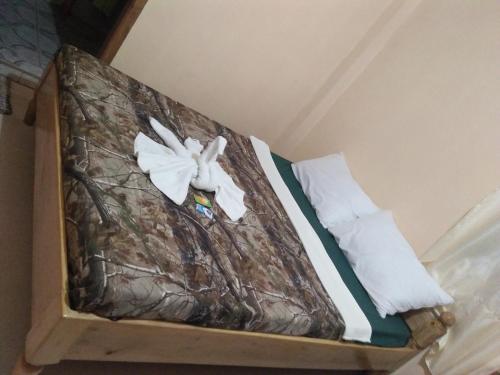 a bed with a white bird decoration on it at Banaue Sunrise Guest House in Banaue
