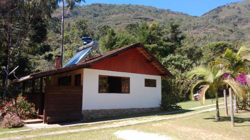 a statue on the roof of a small house at Pousada na Colina in Visconde De Maua
