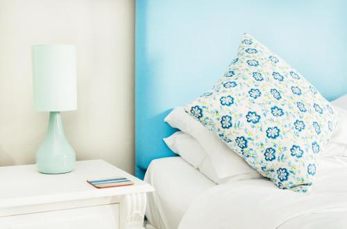 a blue and white bedroom with a pillow on a bed at The Imperial Hotel in St Saviour Guernsey