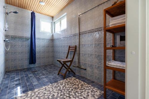 a bathroom with a shower and a chair in it at Terra Ultima in Rovaniemi