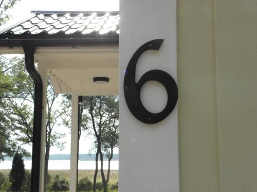 a house number sign on the side of a door at Söderö stugby in Finström