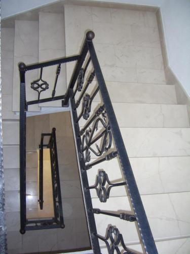 a set of stairs with wrought iron railings at Apartments Villa More in Makarska
