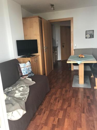a living room with a couch and a table at Apartment Sonnblick in Sankt Johann im Pongau