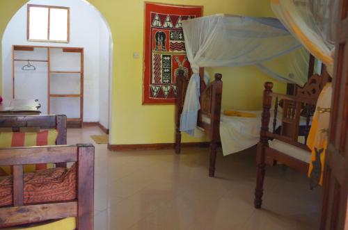 Ένα ή περισσότερα κρεβάτια σε δωμάτιο στο Mbuyuni Beach Village