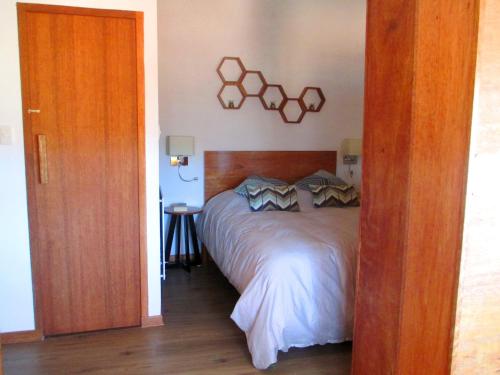 a bedroom with a large bed with a wooden headboard at Quinua Boutique Apartments in Cusco