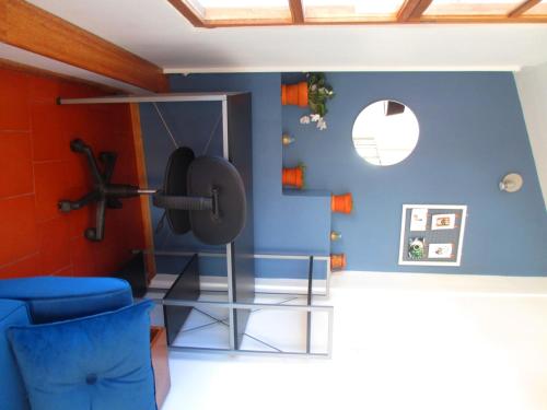 a room with a gym with blue walls at Quinua Boutique Apartments in Cusco