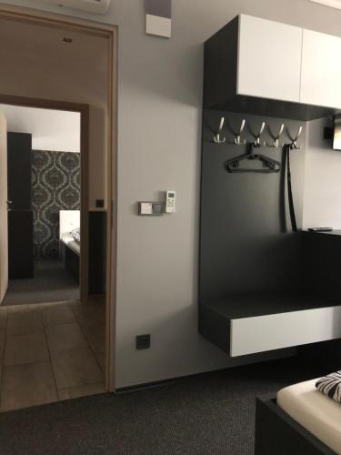a room with a room with a bed and a mirror at Tardosi Vendégház in Miskolctapolca