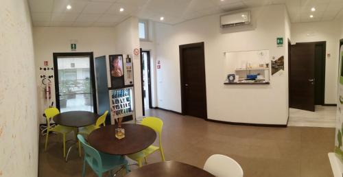 a room with two tables and chairs in a building at Matera Sassi Rooms 21/a e 21/b in Matera