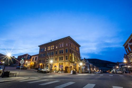 a building on a city street at night at The Victor Hotel in Victor
