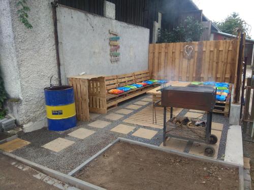 a patio with a grill and a wooden fence at NOVODVORSKÝ APARTMÁN SÁRA in Nové Dvory