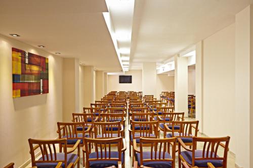 a row of chairs in a room with a screen at MLL Caribbean Bay in El Arenal