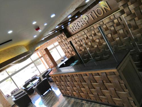 a restaurant with a bar and chairs in a room at Sunset Hotel in Wadi Musa
