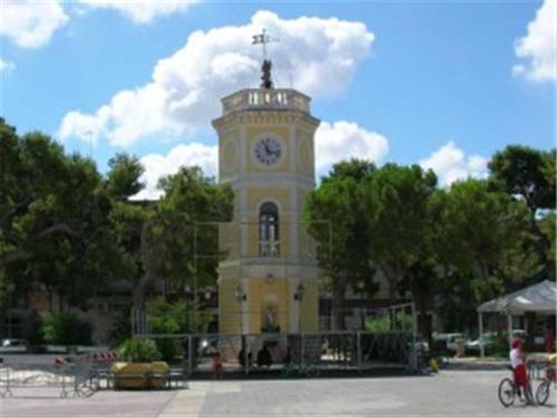 a building with a clock tower on top of it at La Casa della Nonna Francesca in San Ferdinando di Puglia