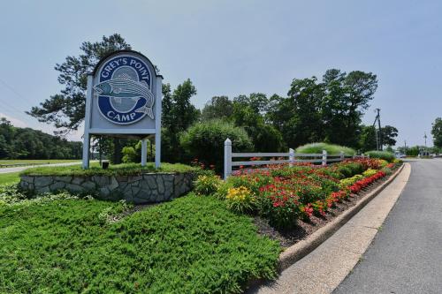a sign on the side of a road with flowers at Grey's Point Camp Cottage 7 in Locklies