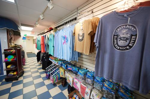 a store aisle with a t shirt and other merchandise at Grey's Point Camp Cottage 7 in Locklies