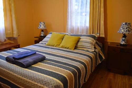 a bed with two pillows on it in a bedroom at Hostal Aventura Austral in Punta Arenas