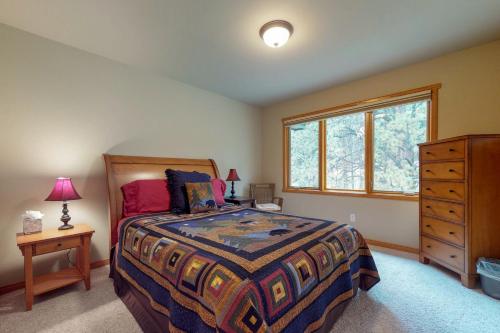 a bedroom with a bed and a dresser and a window at River Retreat - Permit #3517 in Estes Park
