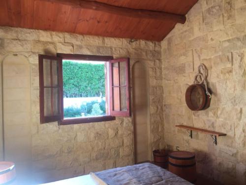 a room with a window in a stone wall at Jasmin Holiday House in Alexandria