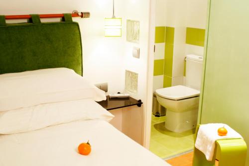 a bedroom with a bed with an orange on it at Hostal Santo Domingo in Madrid