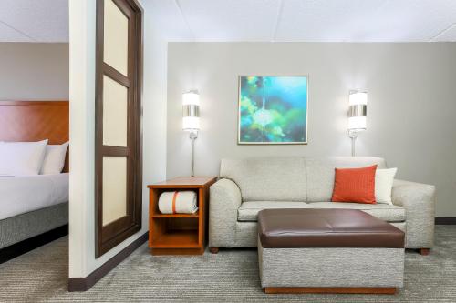 a hotel room with a couch and a bed at Hyatt Place Fort Worth/Hurst in Hurst