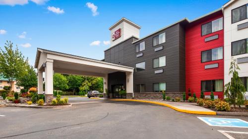 a rendering of a hotel with a red building at Best Western Plus Portland Airport Hotel & Suites in Parkrose